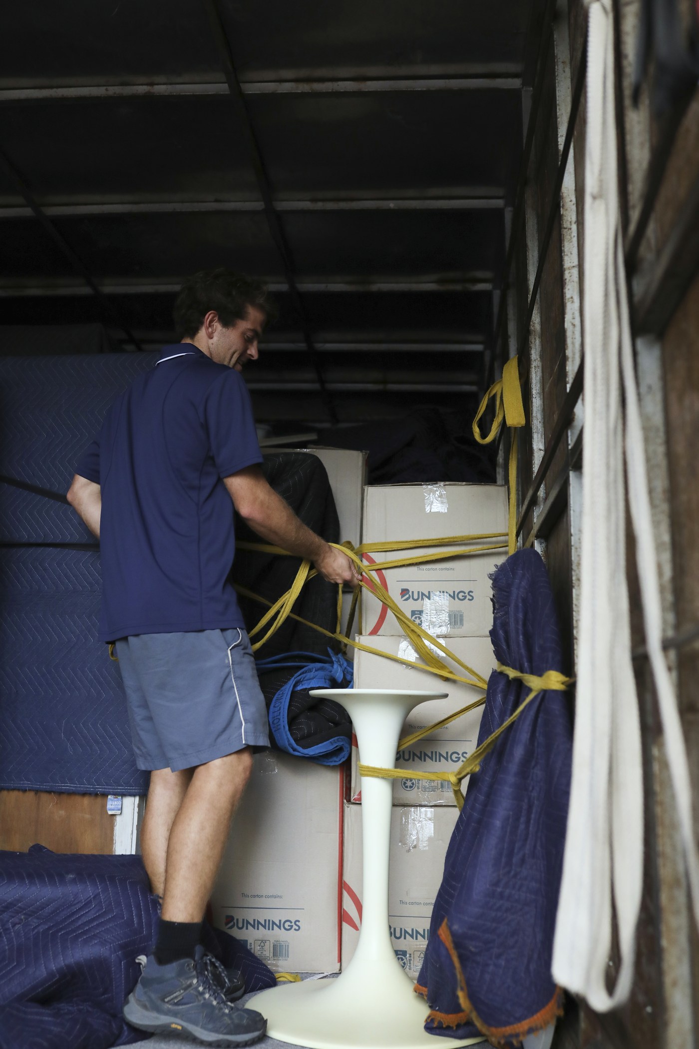 Billy securing items with straps inside the truck