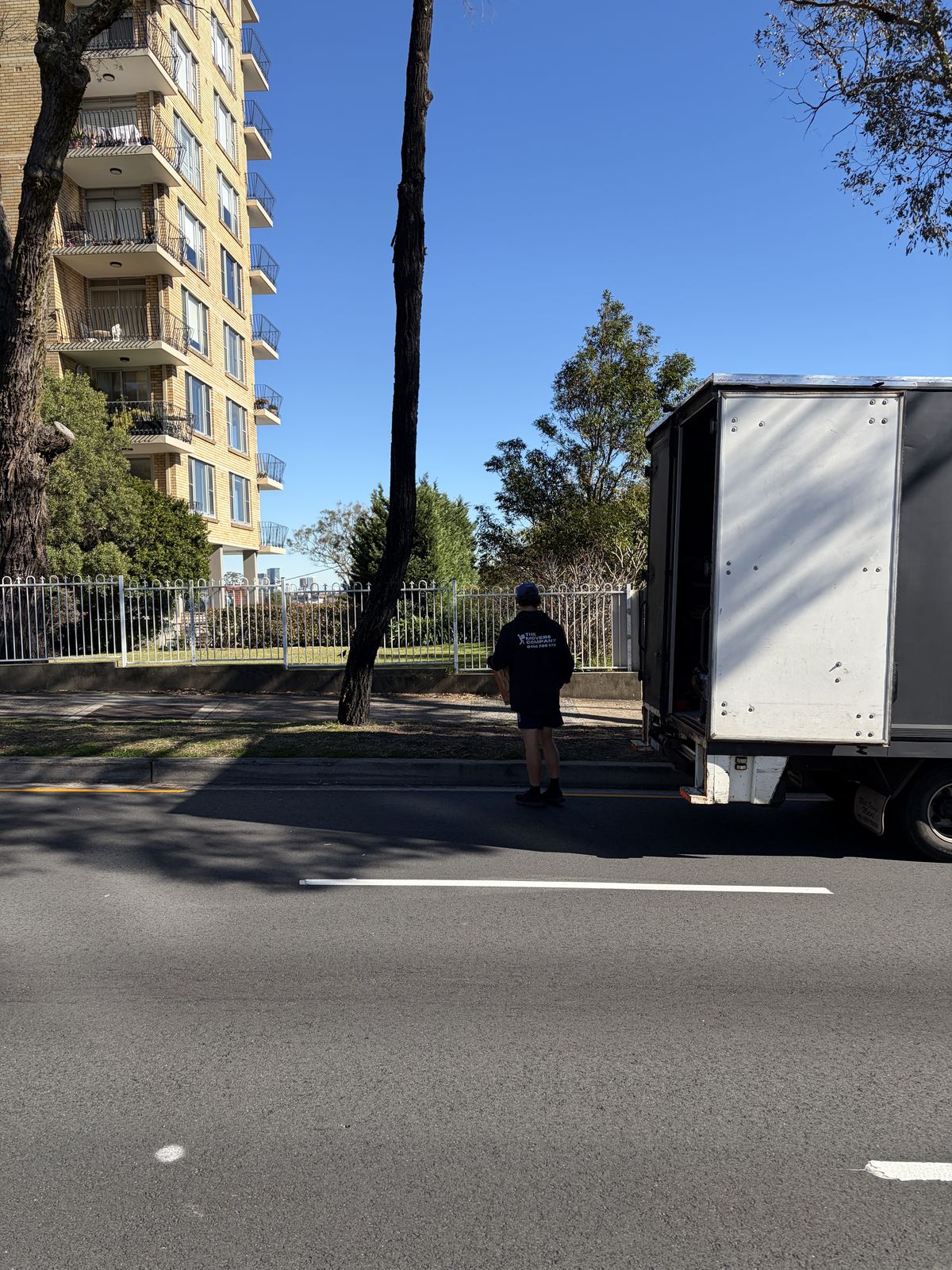 Billy walking towards the truck outside an apartment building