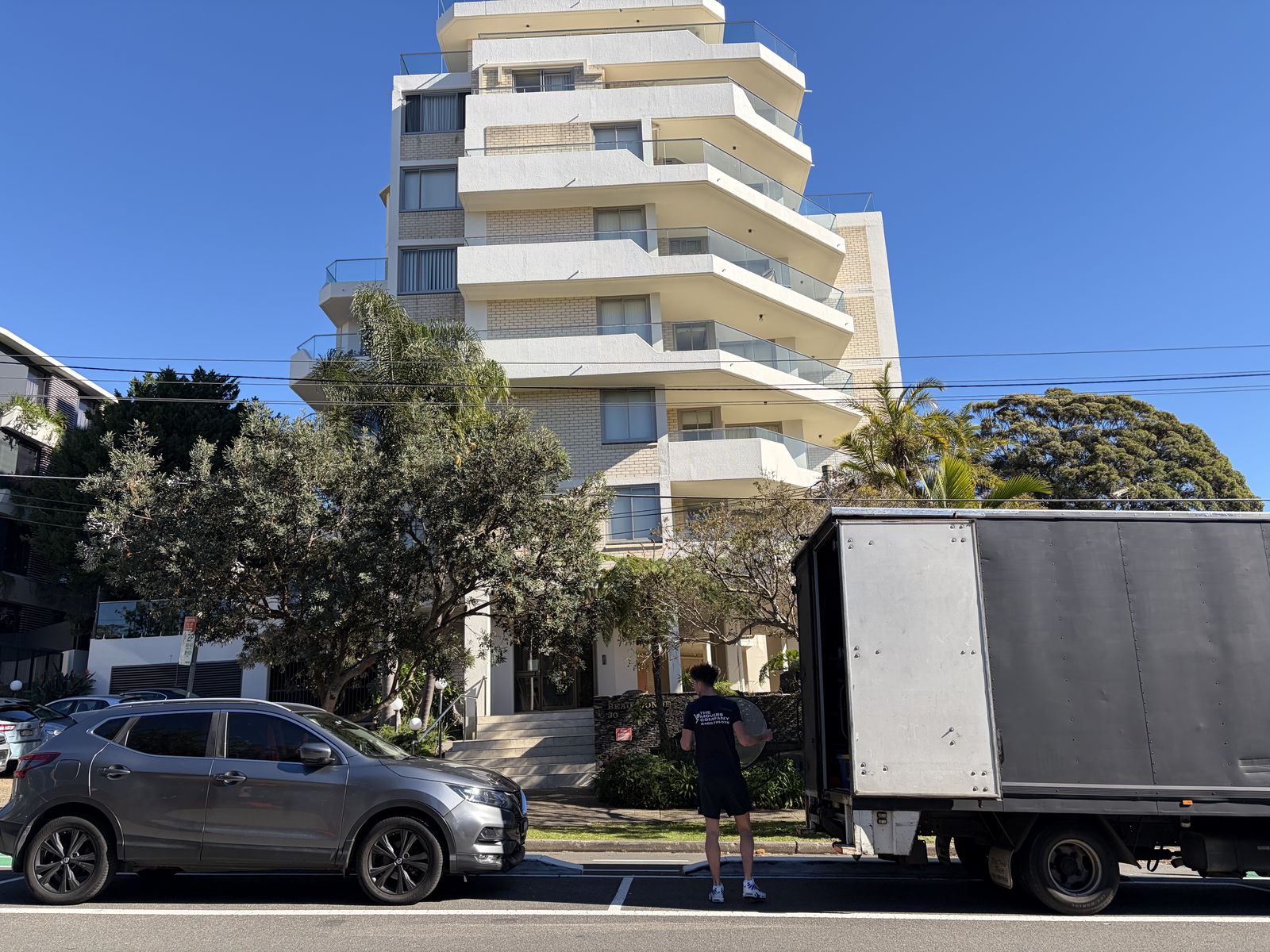 Jet walking towards an apartment building with the truck parked outside