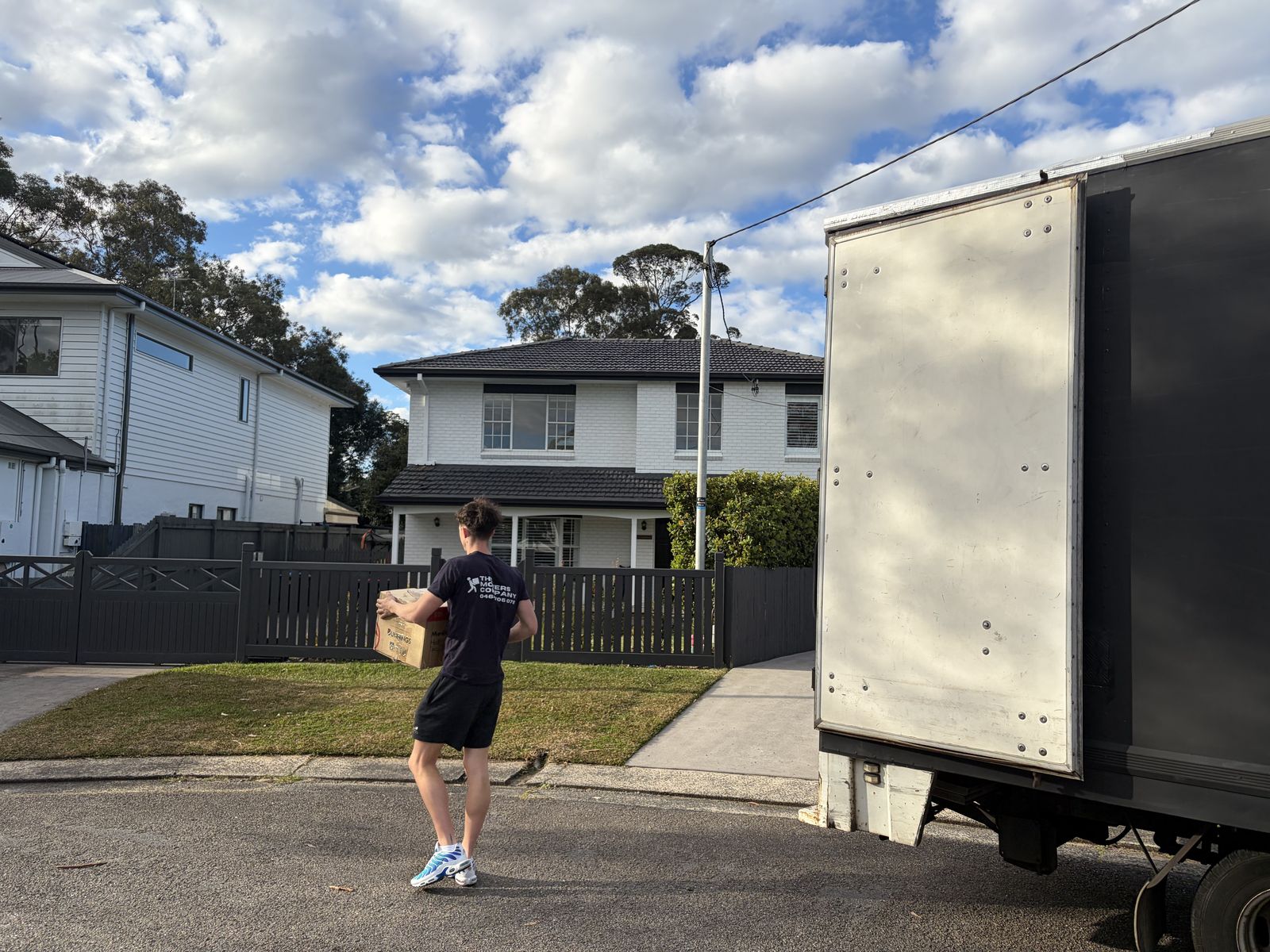 Jet carrying a box towards a house