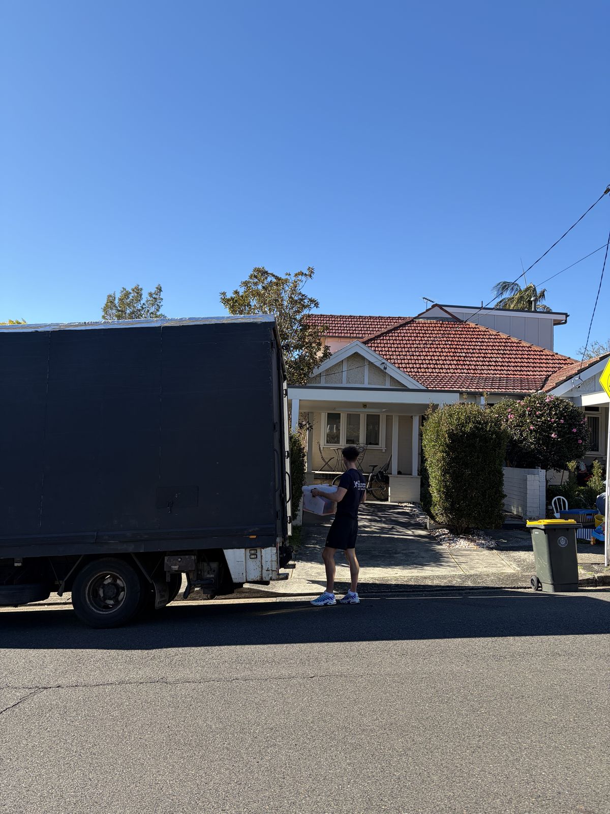 Jet carrying a box up to a house before a move