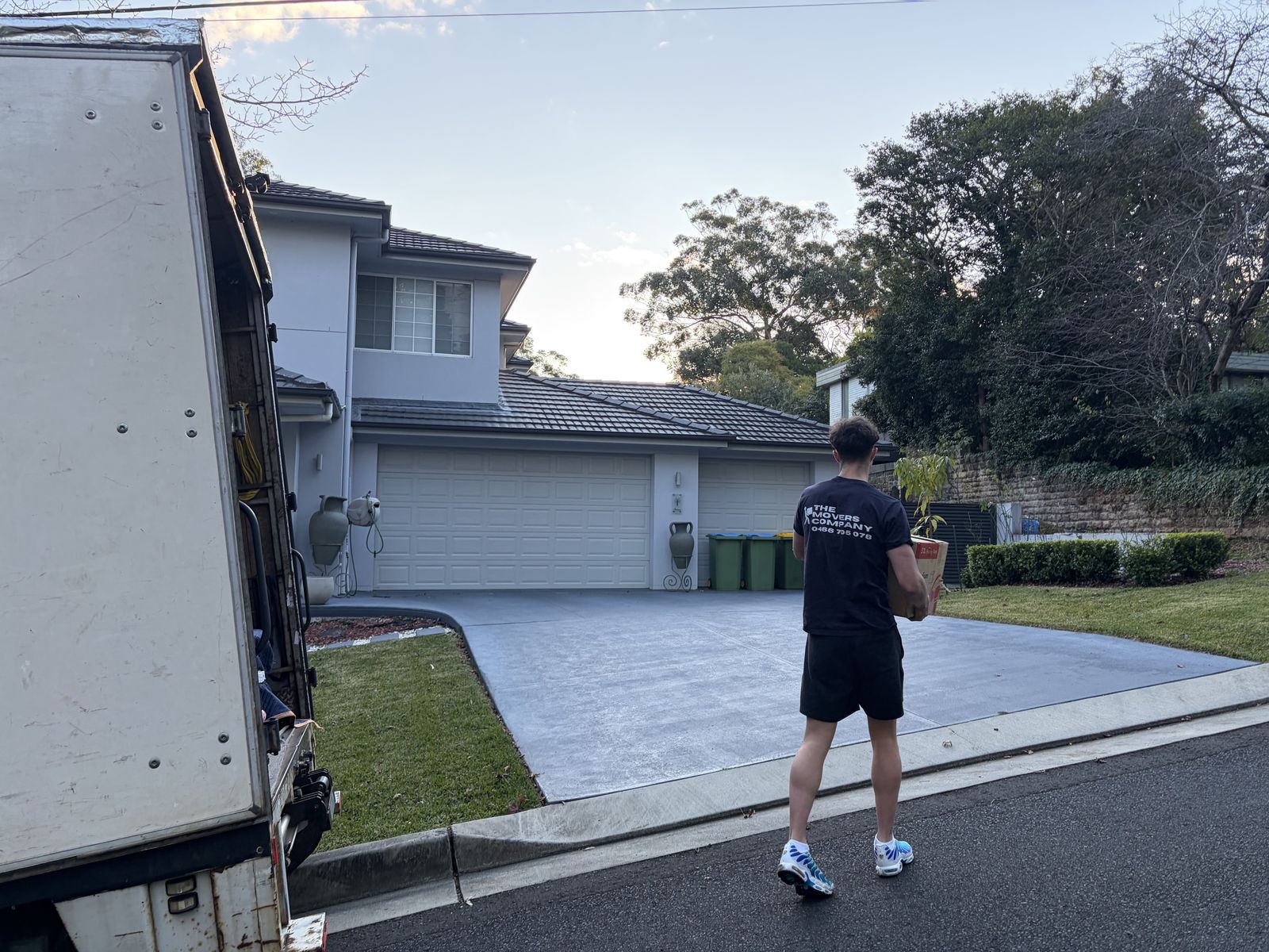 Jet carrying a box towards a two-storey house