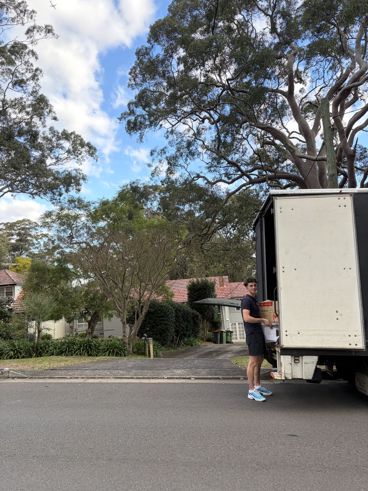 Jet loading a box into the truck under a gum tree