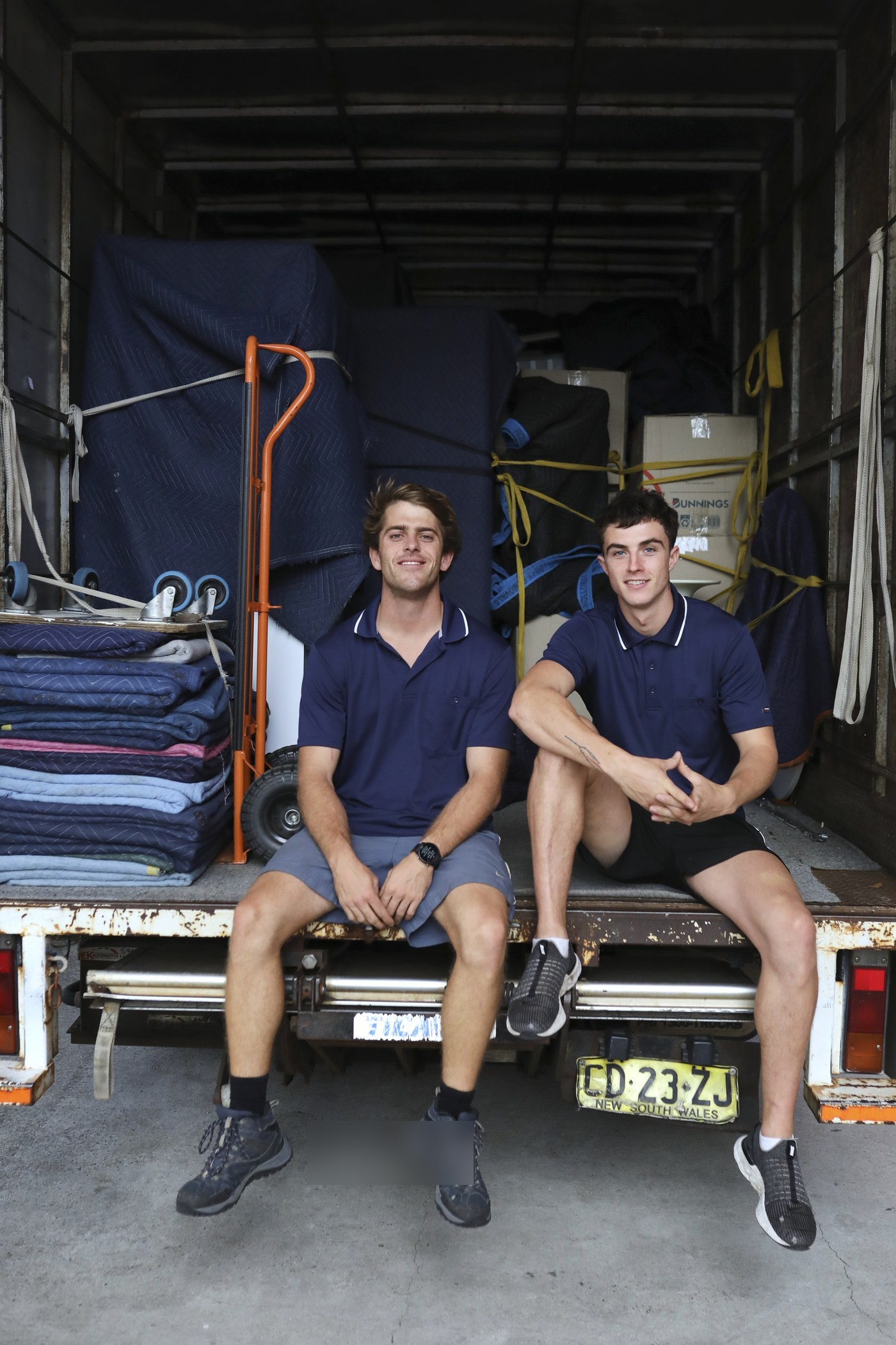 Billy and Jet sitting on the back of the truck