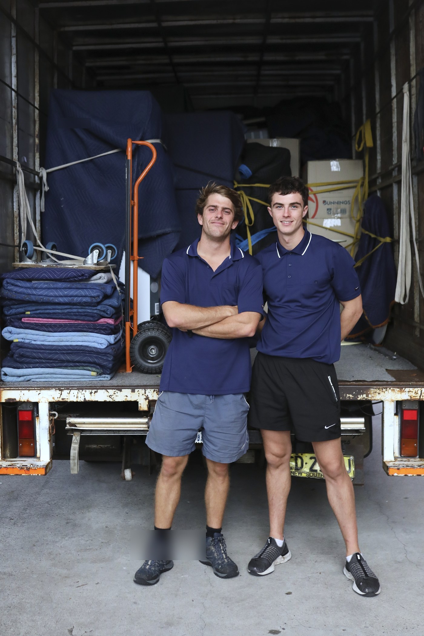 Billy and Jet standing at the back of the truck