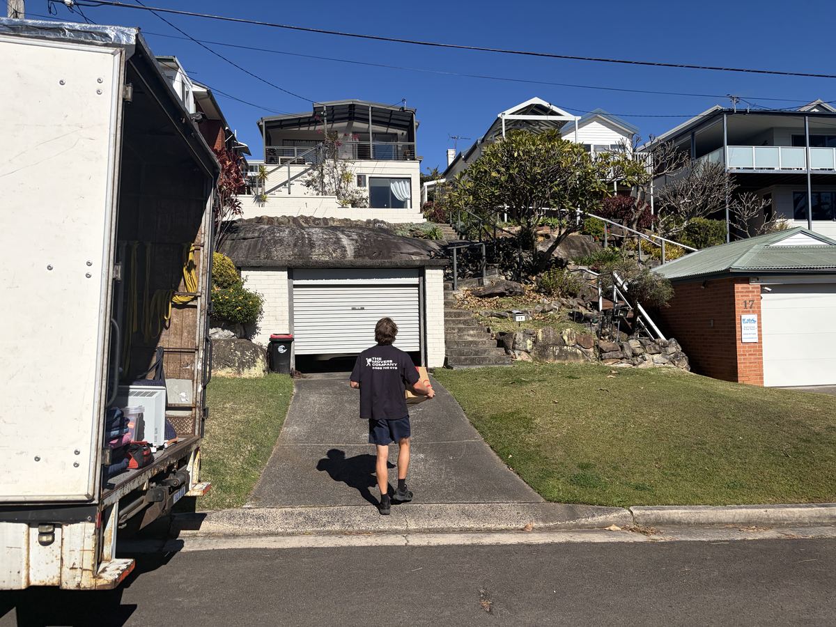 Jet carrying a box up a driveway on a Curl Curl house move