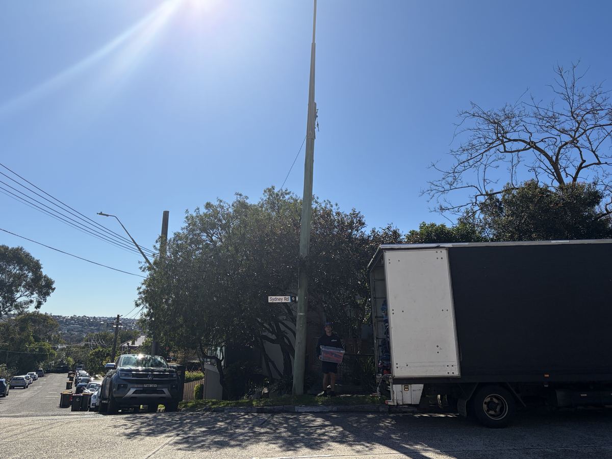 Billy carrying a box beside the truck on a Fairlight house move
