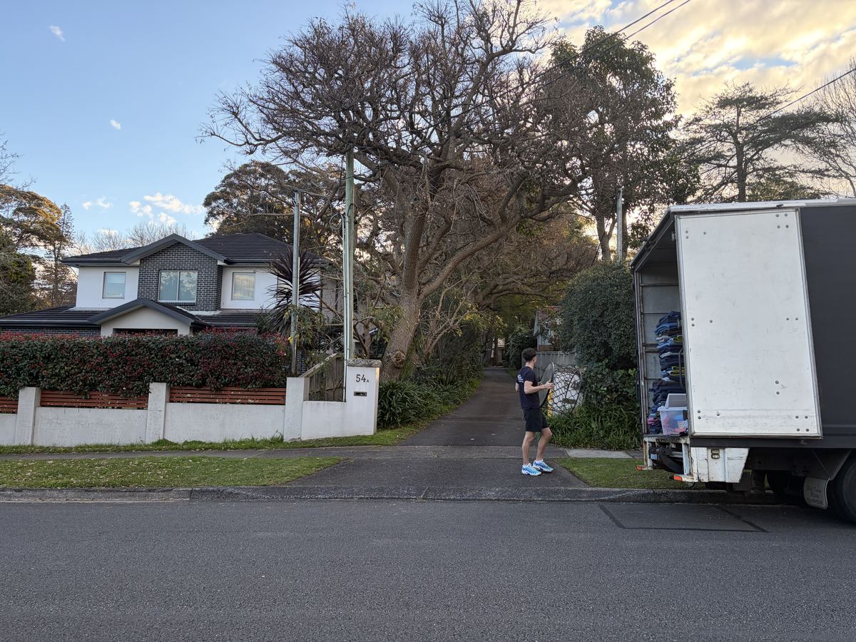 Jet carrying an item up a driveway on a Lane Cove house move