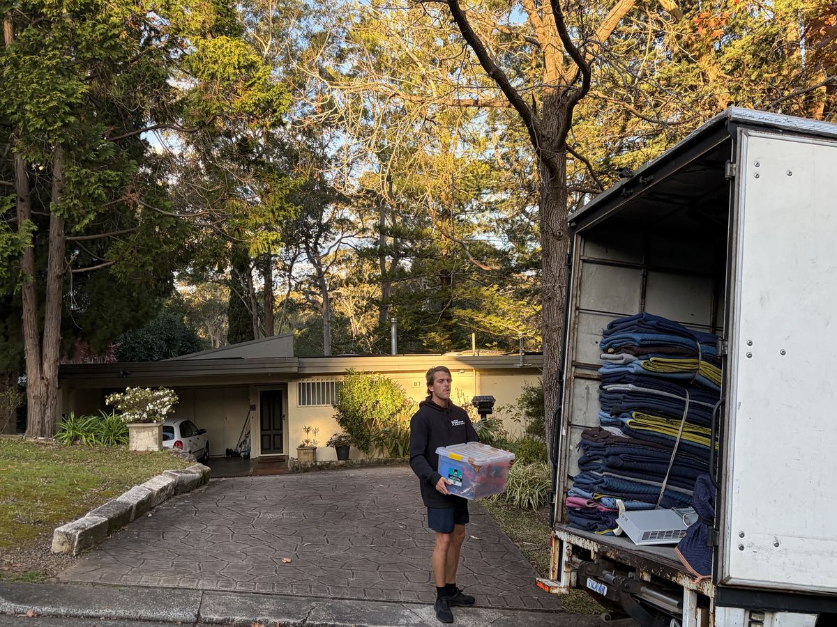 Billy carrying a storage box outside a house in Turramurra, Sydney