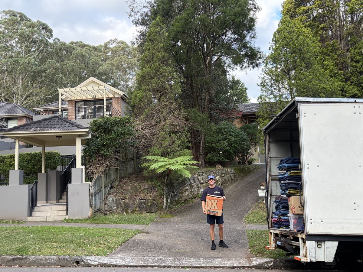 Billy carrying a moving box outside a house in Wahroonga, Sydney